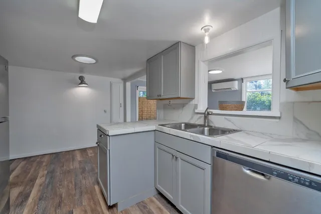 a kitchen with a sink cabinets and window