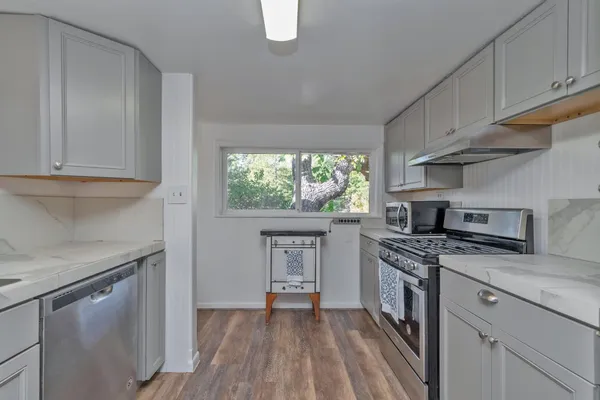 a kitchen with a stove a sink and a refrigerator