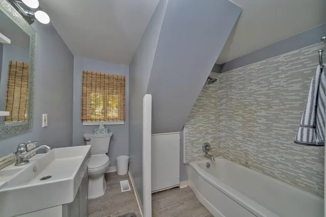 a bathroom with a sink toilet and shower