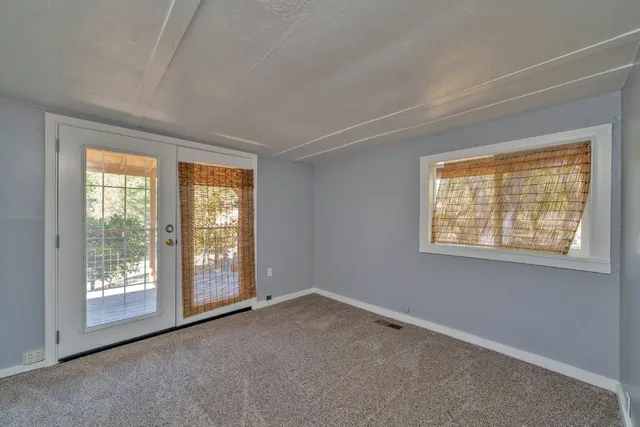 an empty room with closet and entryway