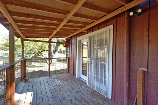 a view of pool with trees and wooden fence