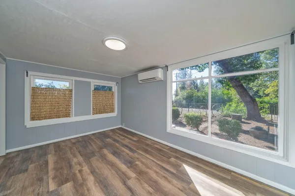 a view of an empty room with a window and a room
