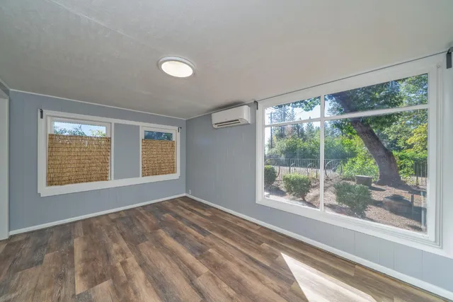 a view of an empty room with a window and a room