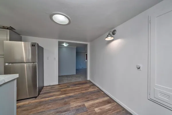 a view of a kitchen from a hallway