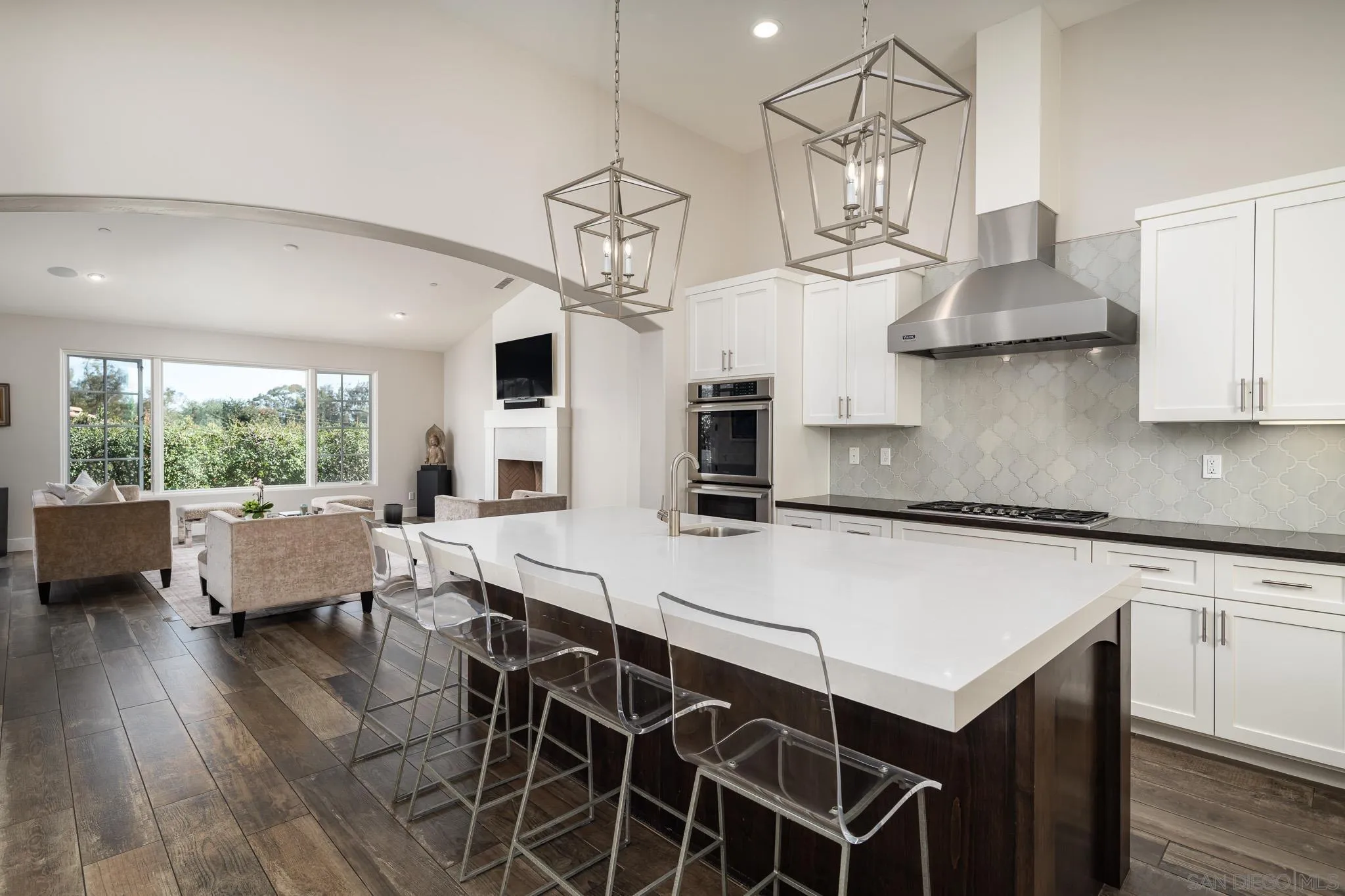 6152 Camino Selva Rancho Santa Fe, CA 92067 - Photo 20 of 37 a kitchen with a table chairs stove and wooden floor