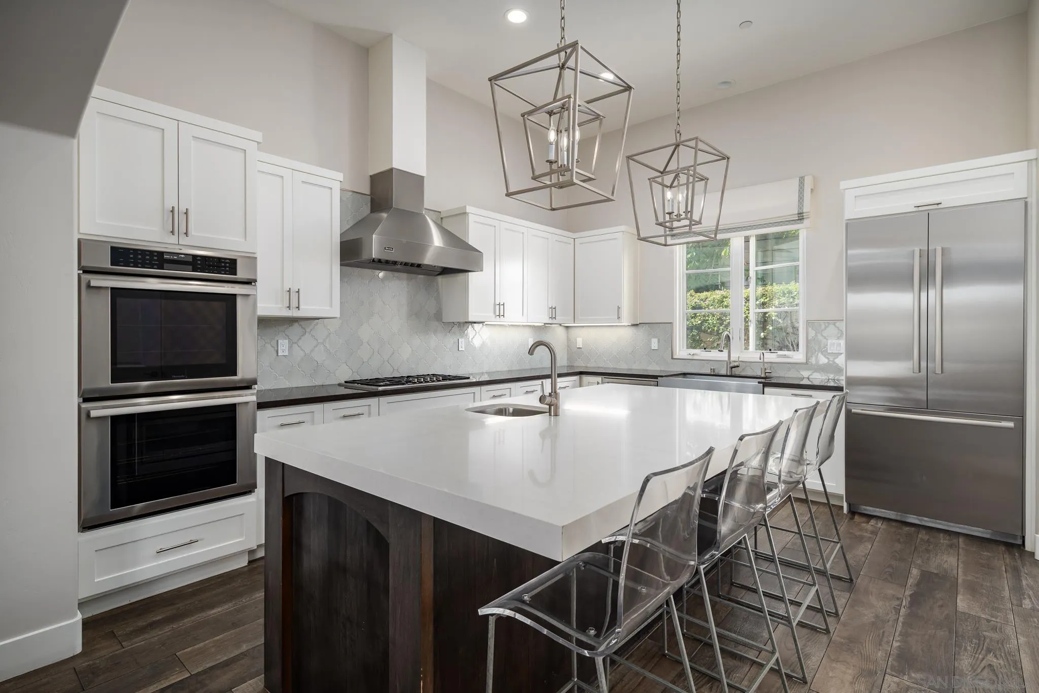 6152 Camino Selva Rancho Santa Fe, CA 92067 - Photo 21 of 37 a kitchen with kitchen island a large counter space appliances and cabinets