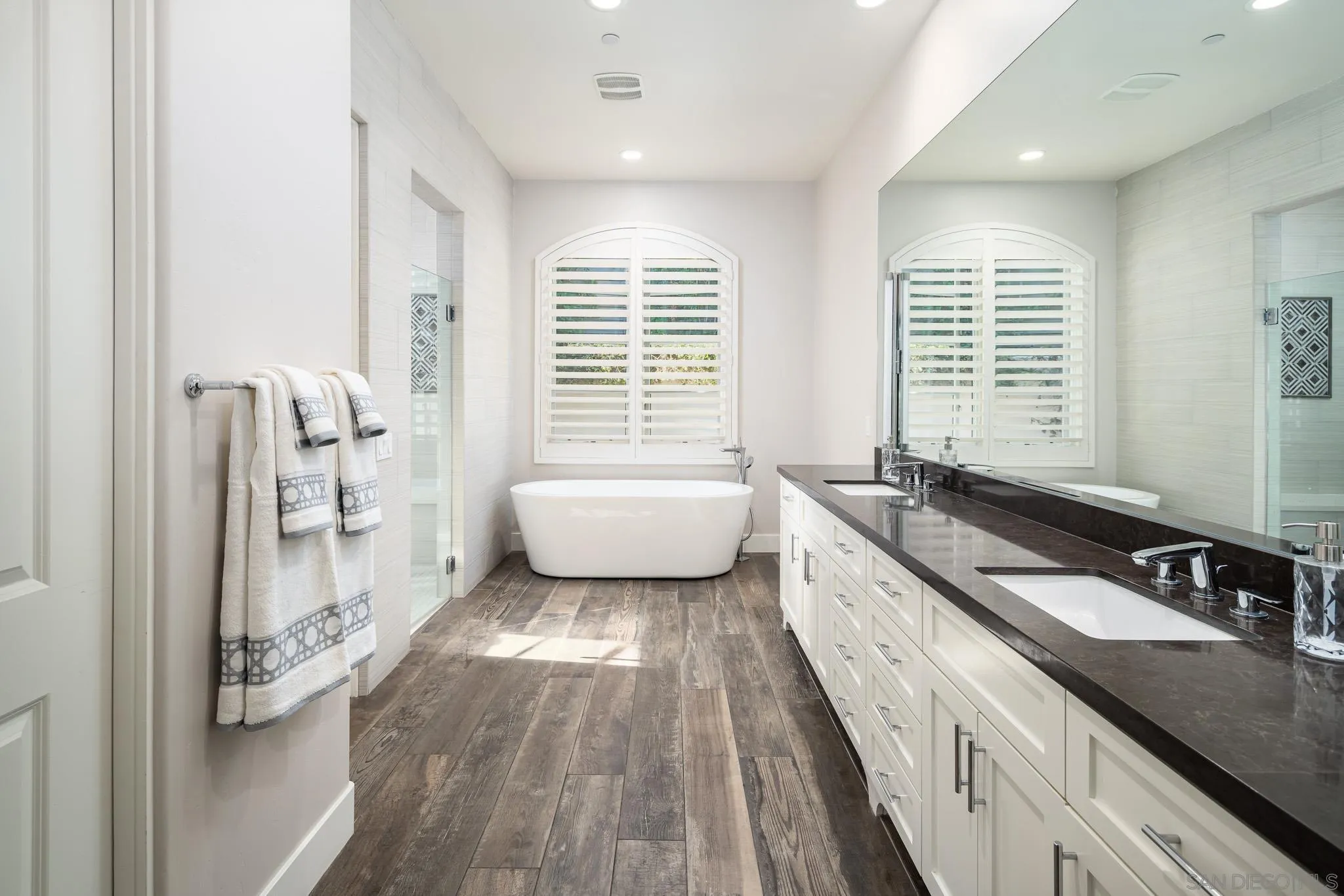 6152 Camino Selva Rancho Santa Fe, CA 92067 - Photo 27 of 37 a spacious bathroom with a double vanity sink a mirror and a bathtub