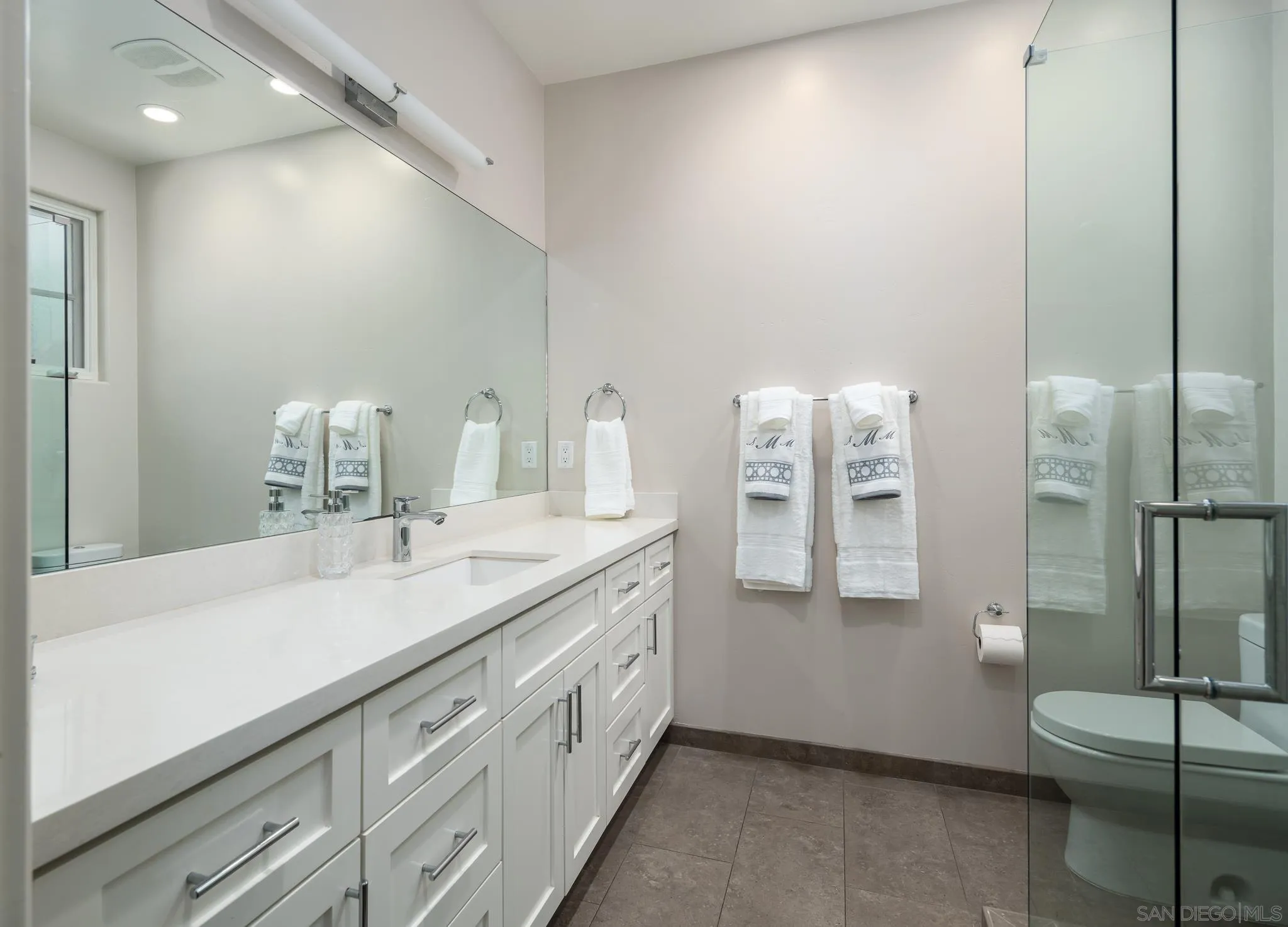 6152 Camino Selva Rancho Santa Fe, CA 92067 - Photo 32 of 37 a spacious bathroom with double vanity and a mirror
