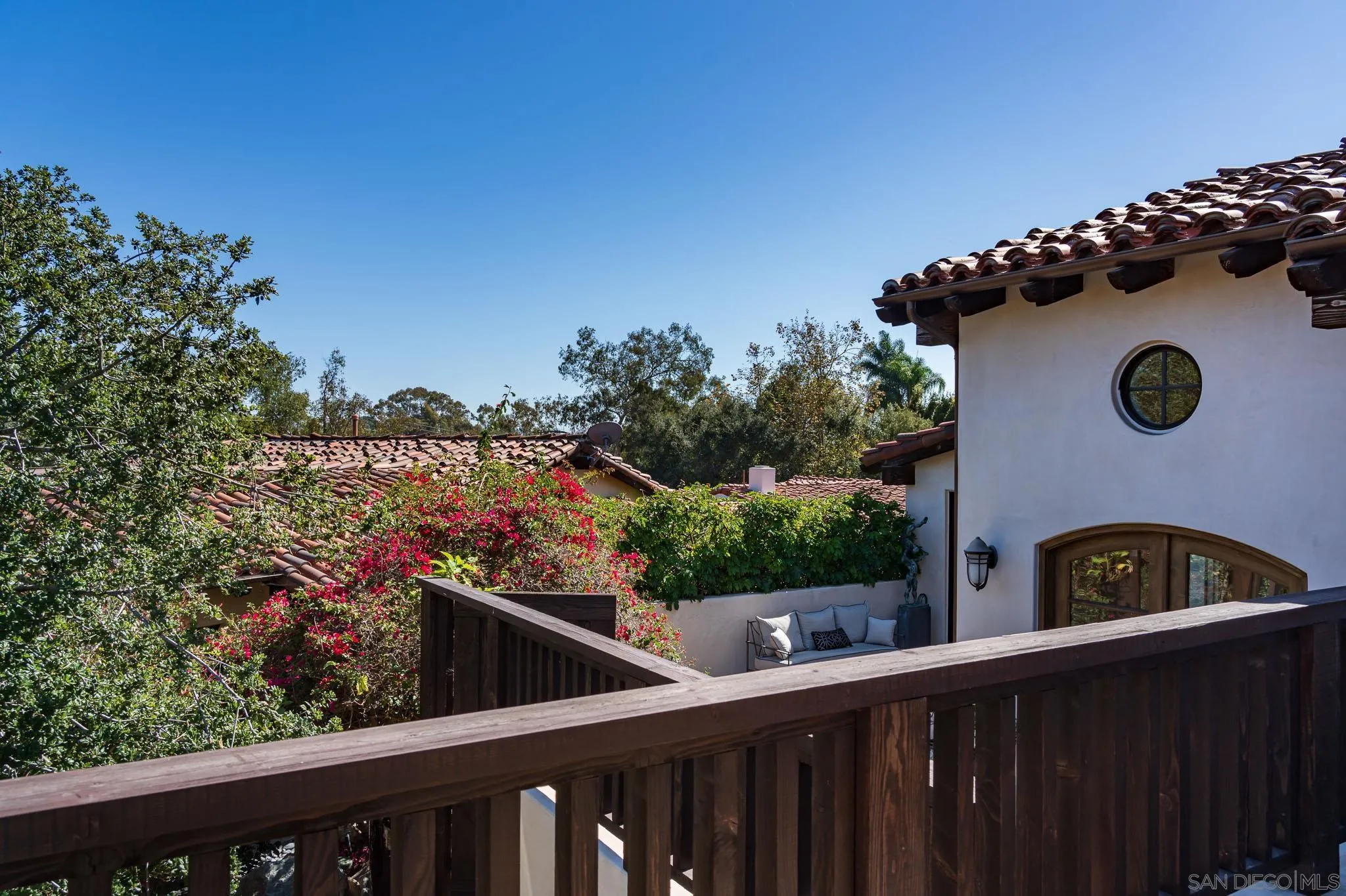 6152 Camino Selva Rancho Santa Fe, CA 92067 - Photo 35 of 37 a view of a wooden fence and a floor to ceiling window