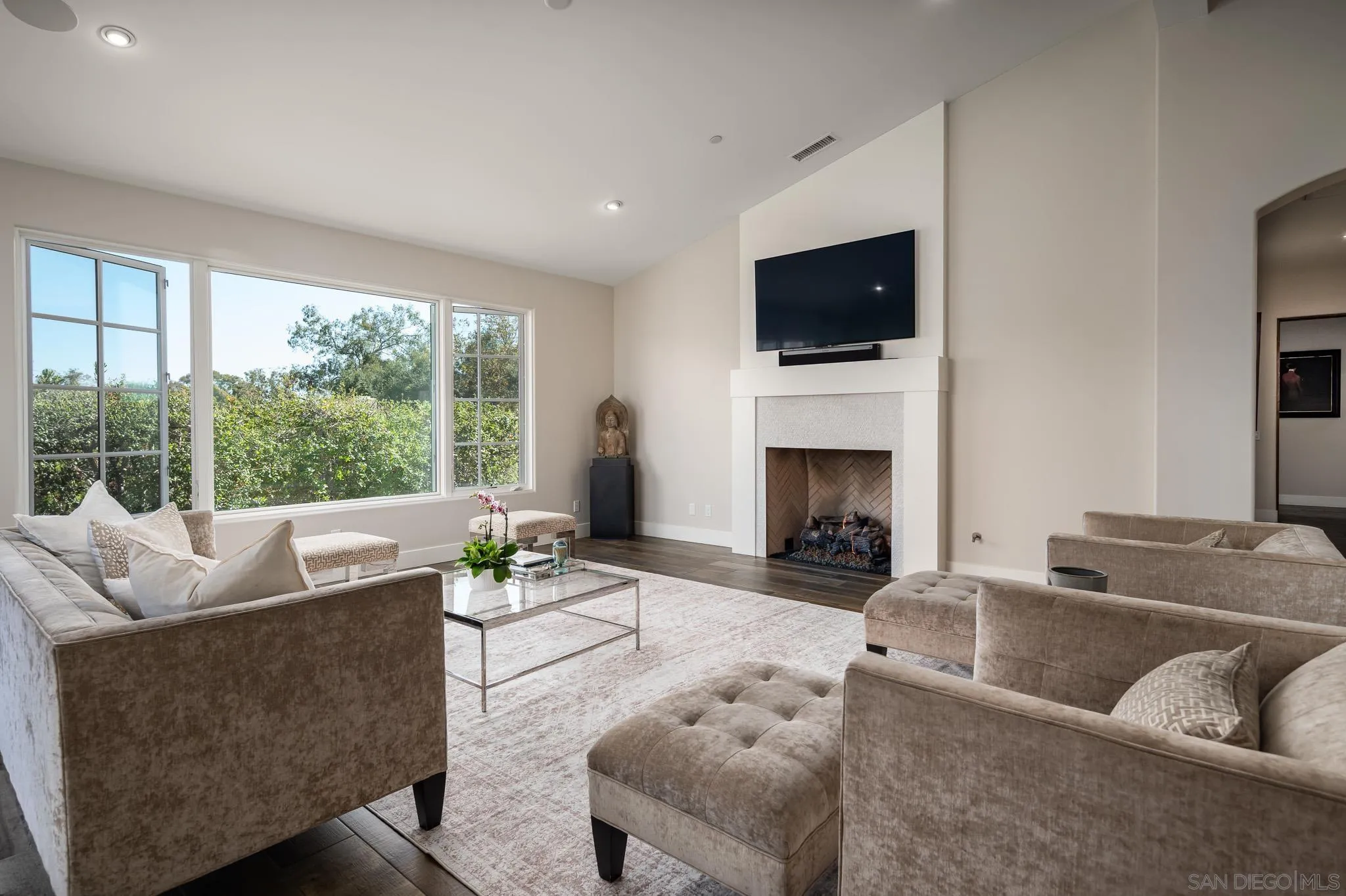 6152 Camino Selva Rancho Santa Fe, CA 92067 - Photo 10 of 37 a living room with furniture a flat screen tv and a fireplace