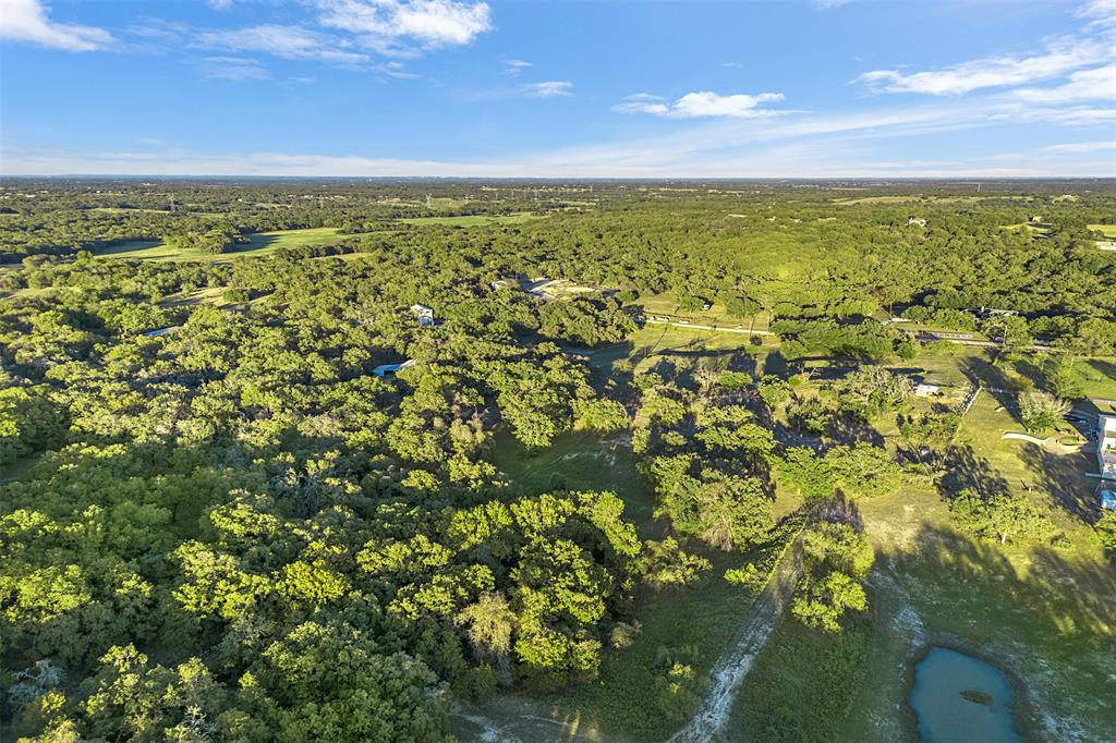 199 Cheyenne Trail Springtown, TX 76082 - Photo 18 of 22 Expansive aerial perspective showcasing a verdant landscape with extensive tree coverage and open clearings