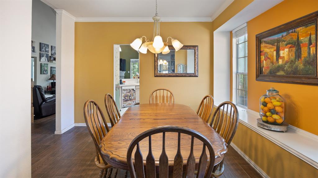 1508 Valley Creek Road Denton, TX 76205 - Photo 19 of 33 a dining room with furniture potted plants and wooden floor