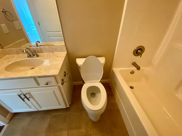 a bathroom with a sink mirror and toilet