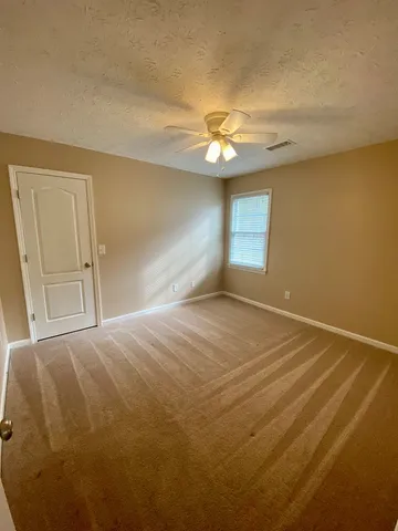 a view of empty room with a ceiling fan