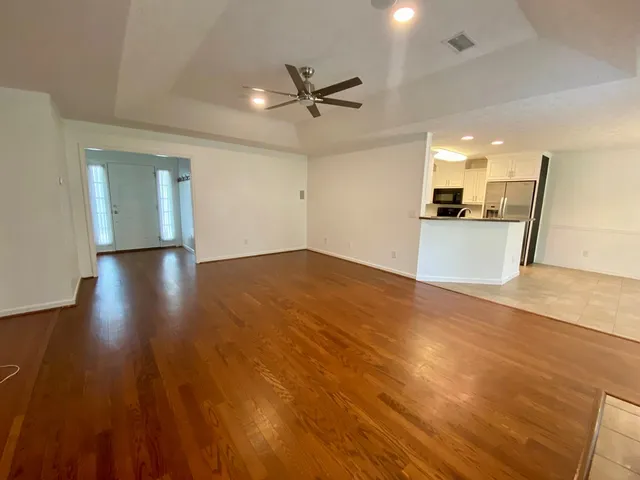 a view of a kitchen with a sink and wooden floor