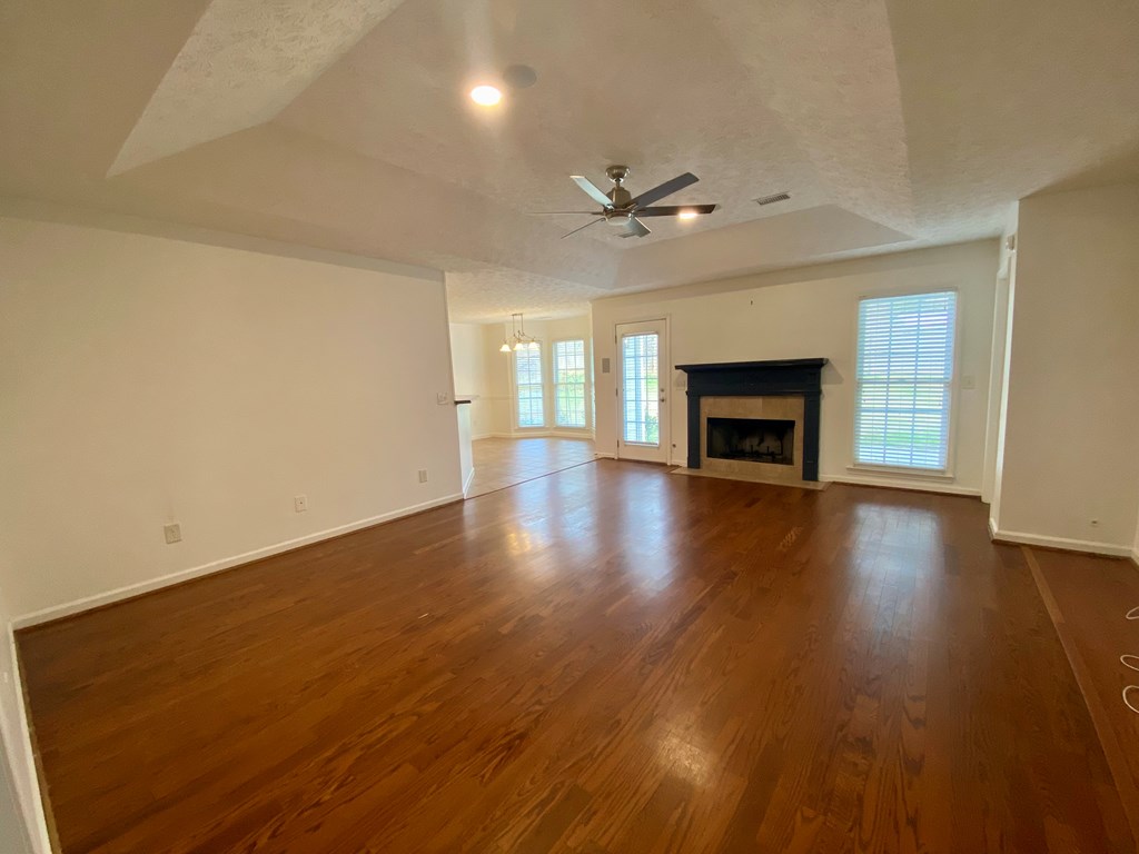 1815 Saffron Court Columbus, GA 31909 - Photo 4 of 20 a view of an empty room with a fireplace and a window