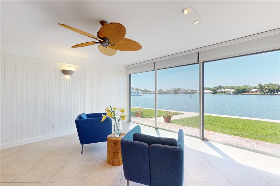 a living room with furniture and a floor to ceiling window