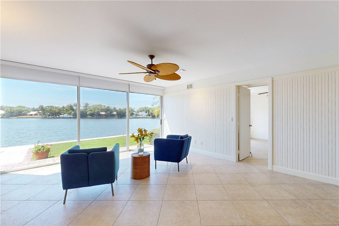 550 Riomar Drive, Unit 24 Vero Beach, FL 32963 - Photo 11 of 35 a living room with furniture and a floor to ceiling window