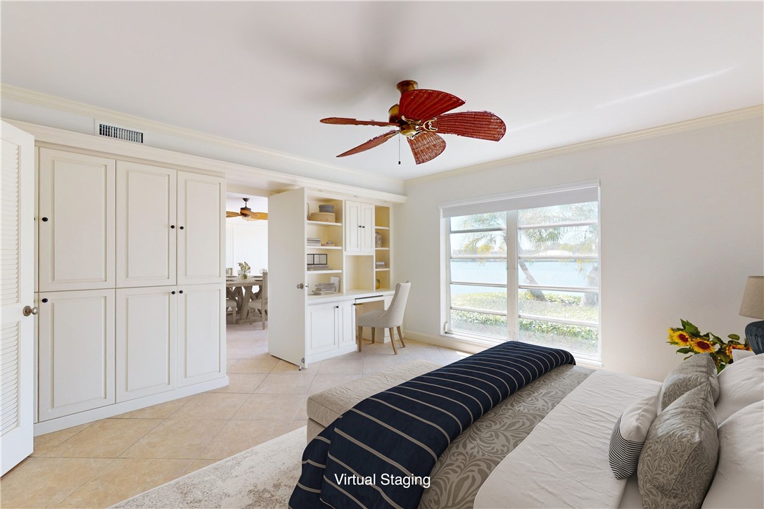 550 Riomar Drive, Unit 24 Vero Beach, FL 32963 - Photo 14 of 35 a bedroom with a bed and a large window