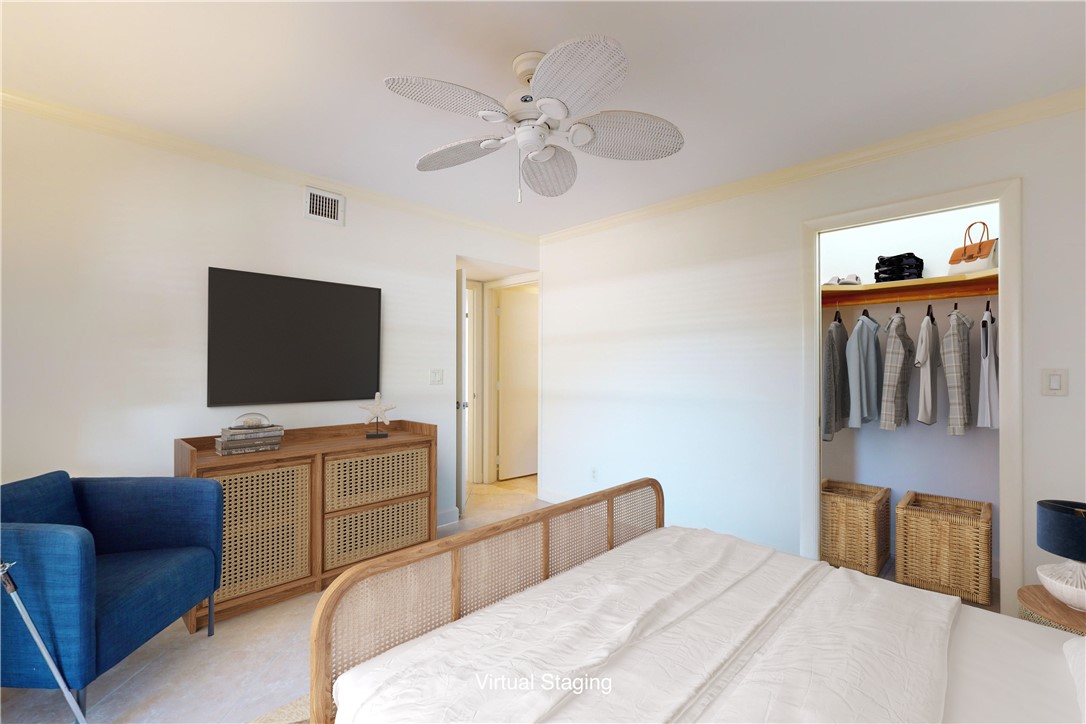 550 Riomar Drive, Unit 24 Vero Beach, FL 32963 - Photo 20 of 35 a bedroom with a bed and a flat screen tv