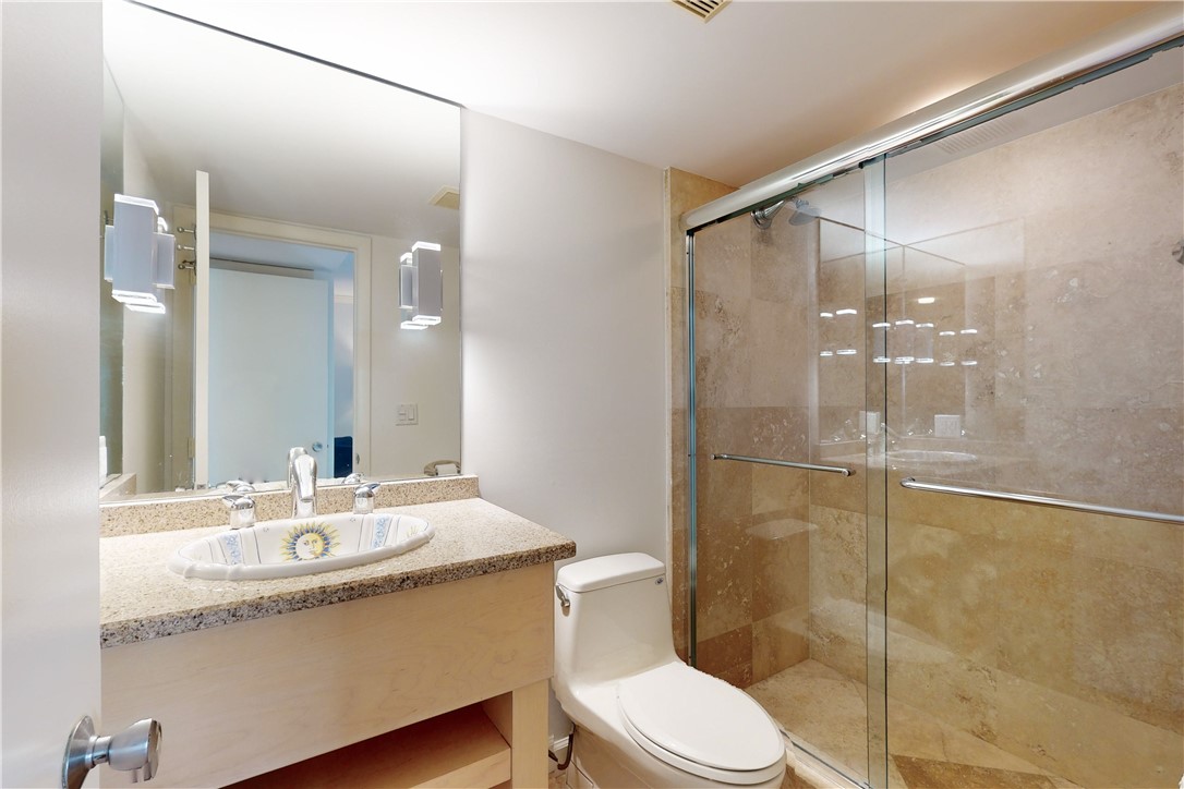 550 Riomar Drive, Unit 24 Vero Beach, FL 32963 - Photo 22 of 35 a bathroom with a granite countertop sink mirror toilet and shower