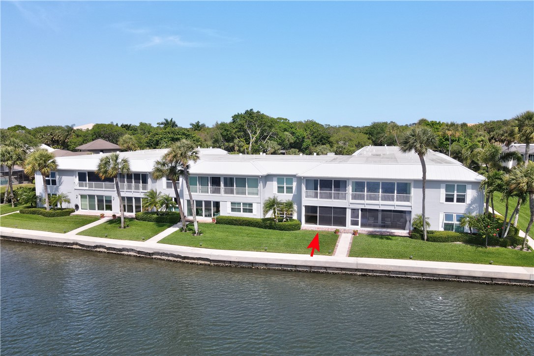 550 Riomar Drive, Unit 24 Vero Beach, FL 32963 - Photo 24 of 35 a front view of a house with a garden and lake view