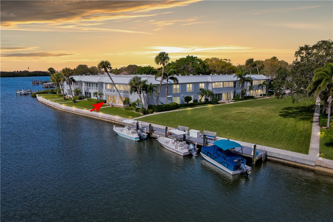 550 Riomar Drive, Unit 24 Vero Beach, FL 32963 - Photo 3 of 35 a view of a swimming pool with lawn chairs and a yard