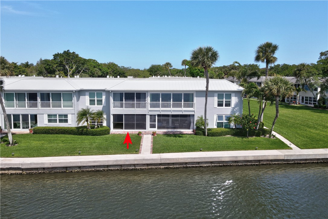 550 Riomar Drive, Unit 24 Vero Beach, FL 32963 - Photo 31 of 35 a front view of a house with a yard and a swimming pool