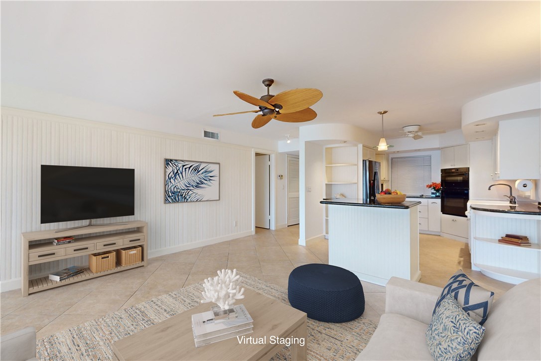 550 Riomar Drive, Unit 24 Vero Beach, FL 32963 - Photo 6 of 35 a living room with furniture and a flat screen tv