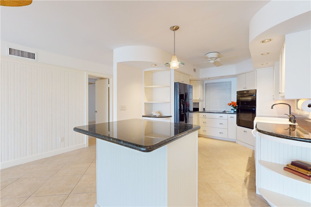 550 Riomar Drive, Unit 24 Vero Beach, FL 32963 - Photo 10 of 35 a kitchen with stainless steel appliances granite countertop a sink a stove and a refrigerator
