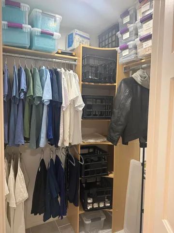 a view of an empty room with a fireplace and a window