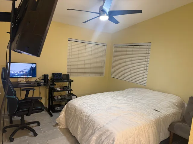 a bathroom with a granite countertop shower and a toilet