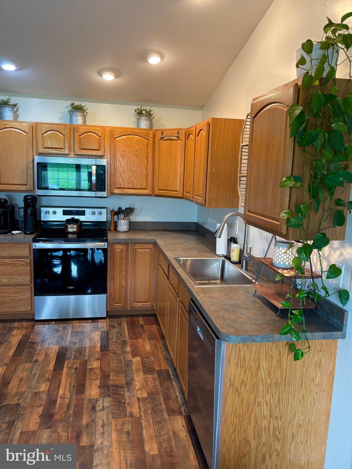 56 Reprisal Road Inwood, WV 25428 - Photo 11 of 31 a kitchen with stainless steel appliances granite countertop a stove a sink and a microwave