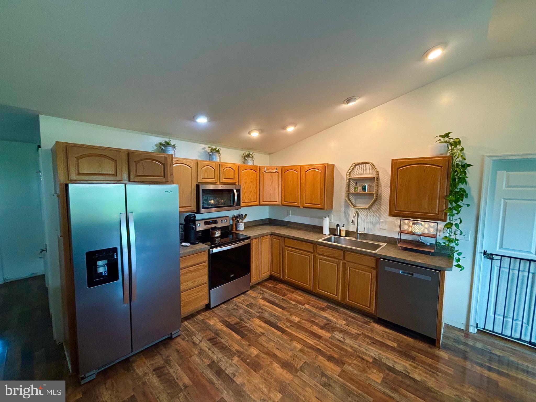 56 Reprisal Road Inwood, WV 25428 - Photo 5 of 31 a kitchen with stainless steel appliances granite countertop a refrigerator a stove and a sink