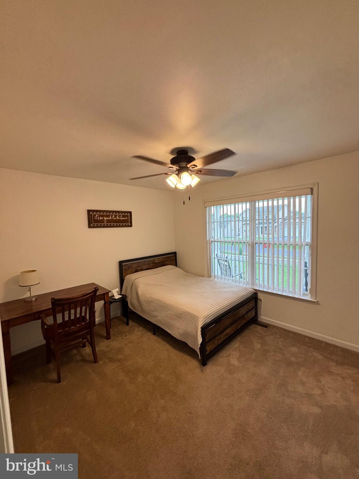 56 Reprisal Road Inwood, WV 25428 - Photo 8 of 31 a bedroom with a bed and a chandelier