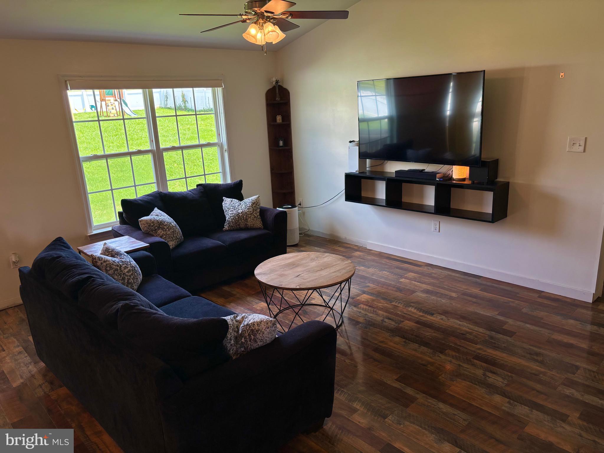 56 Reprisal Road Inwood, WV 25428 - Photo 10 of 31 a living room with furniture and a flat screen tv