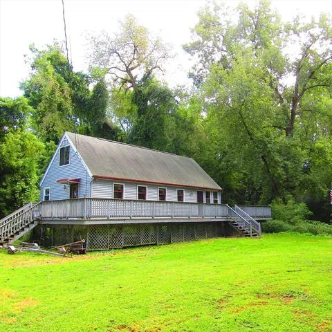 a house with swimming pool in front of it