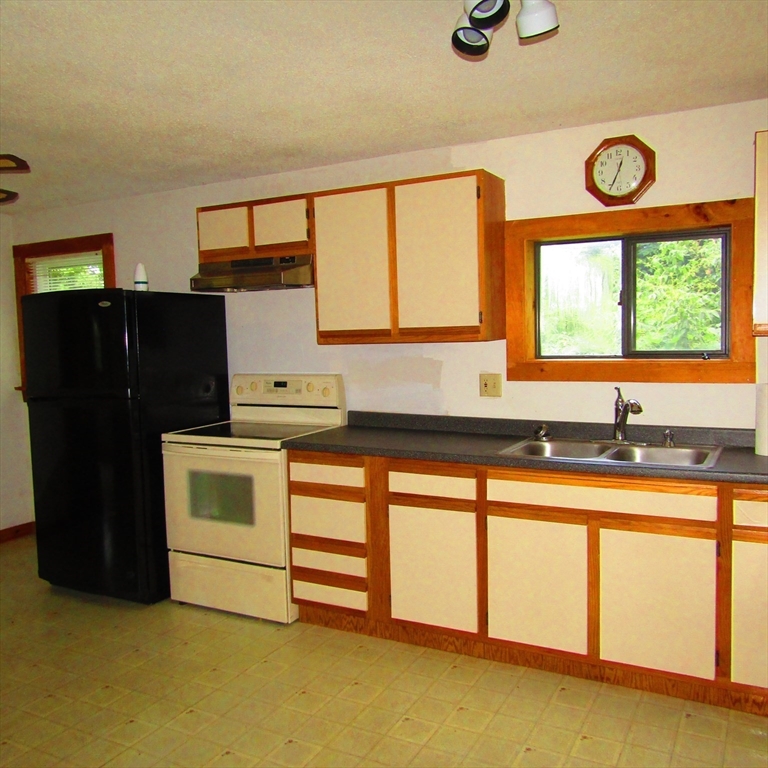79 Aqua Vitae Road Hadley, MA 01035 - Photo 7 of 25 a kitchen with a refrigerator and a sink