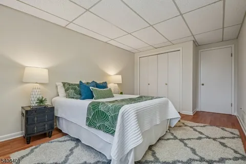 a spacious bedroom with a bed and a lamp