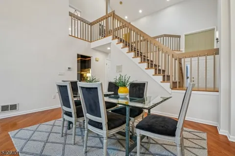 a view of entryway dining room and hall with wooden floor