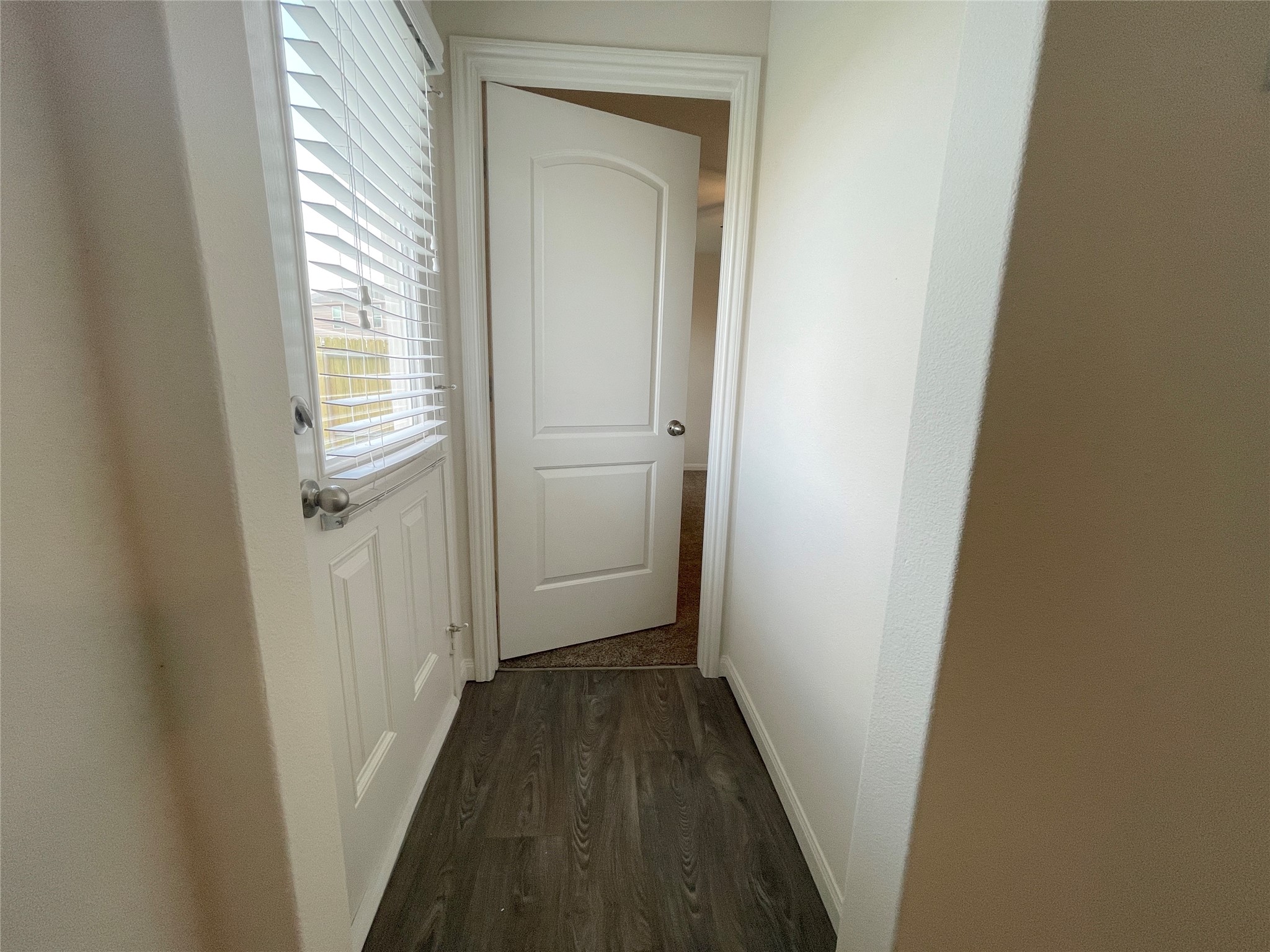 20714 Round Key Drive Hockley, TX 77447 - Photo 12 of 20 a view of a hallway with wooden floor and a door