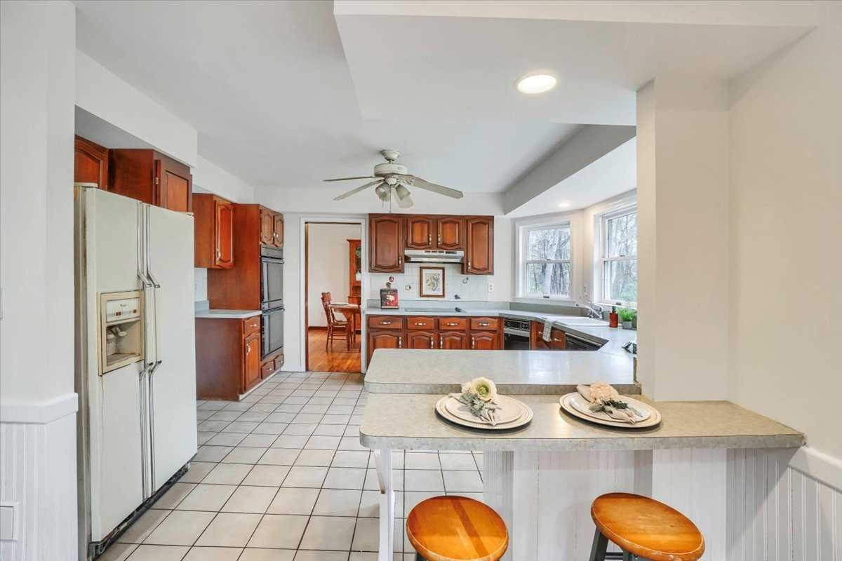 158 Bohl Road East Fishkill, NY 12533 - Photo 14 of 39 a kitchen with stainless steel appliances wooden floor and refrigerator