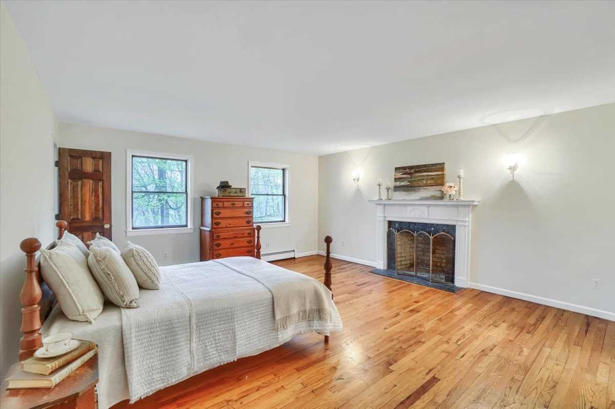 158 Bohl Road East Fishkill, NY 12533 - Photo 22 of 39 a bedroom with a bed and a fireplace