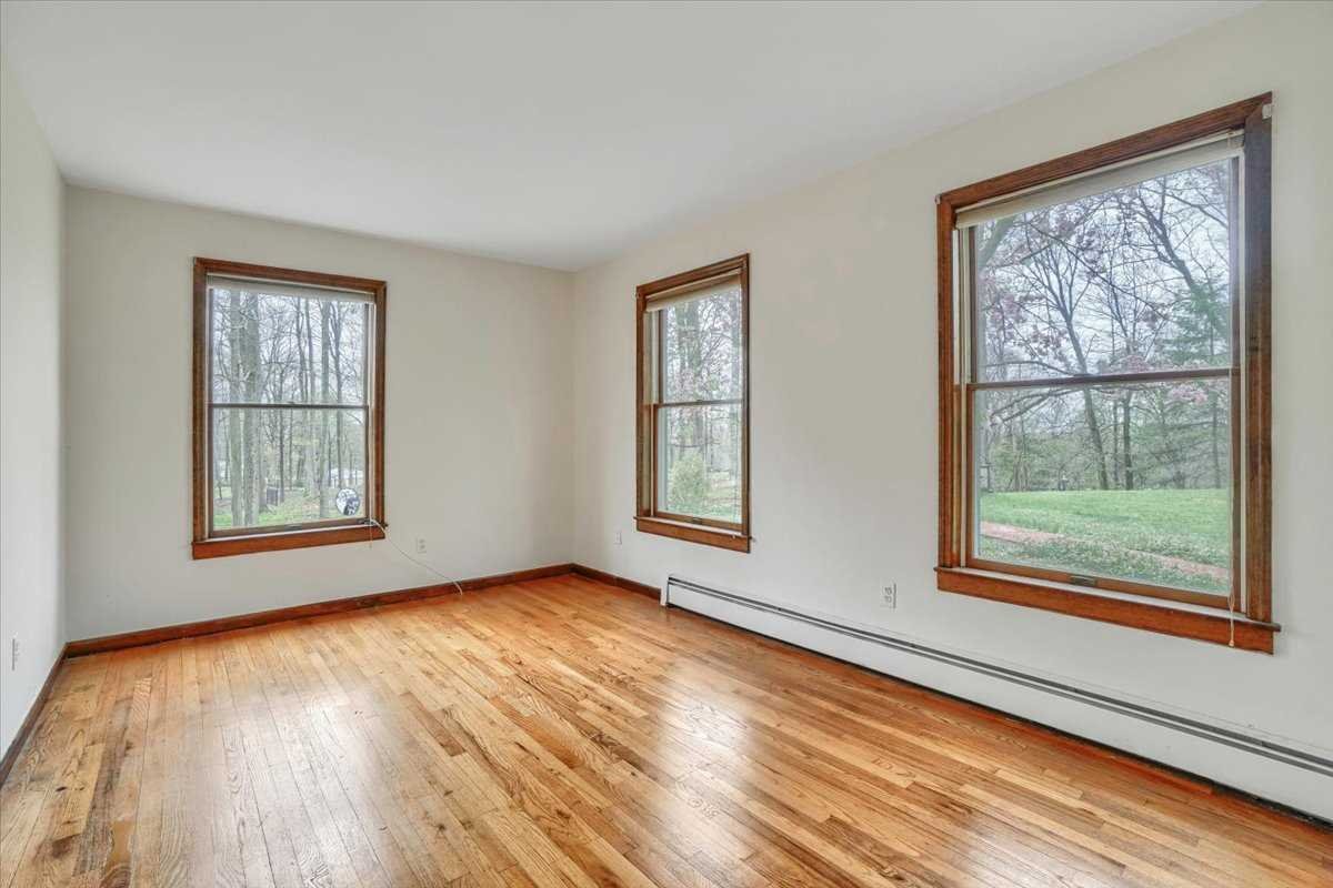 158 Bohl Road East Fishkill, NY 12533 - Photo 8 of 39 a view of an empty room with wooden floor and a window