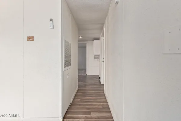a view of a hallway with wooden floor