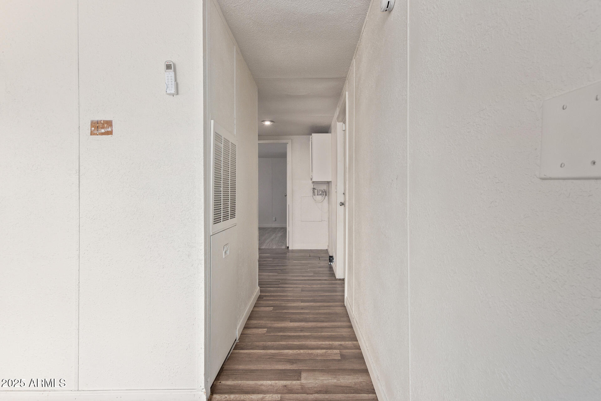 1221 North Dysart Road, Unit 35 Avondale, AZ 85323 - Photo 13 of 22 a view of a hallway with wooden floor