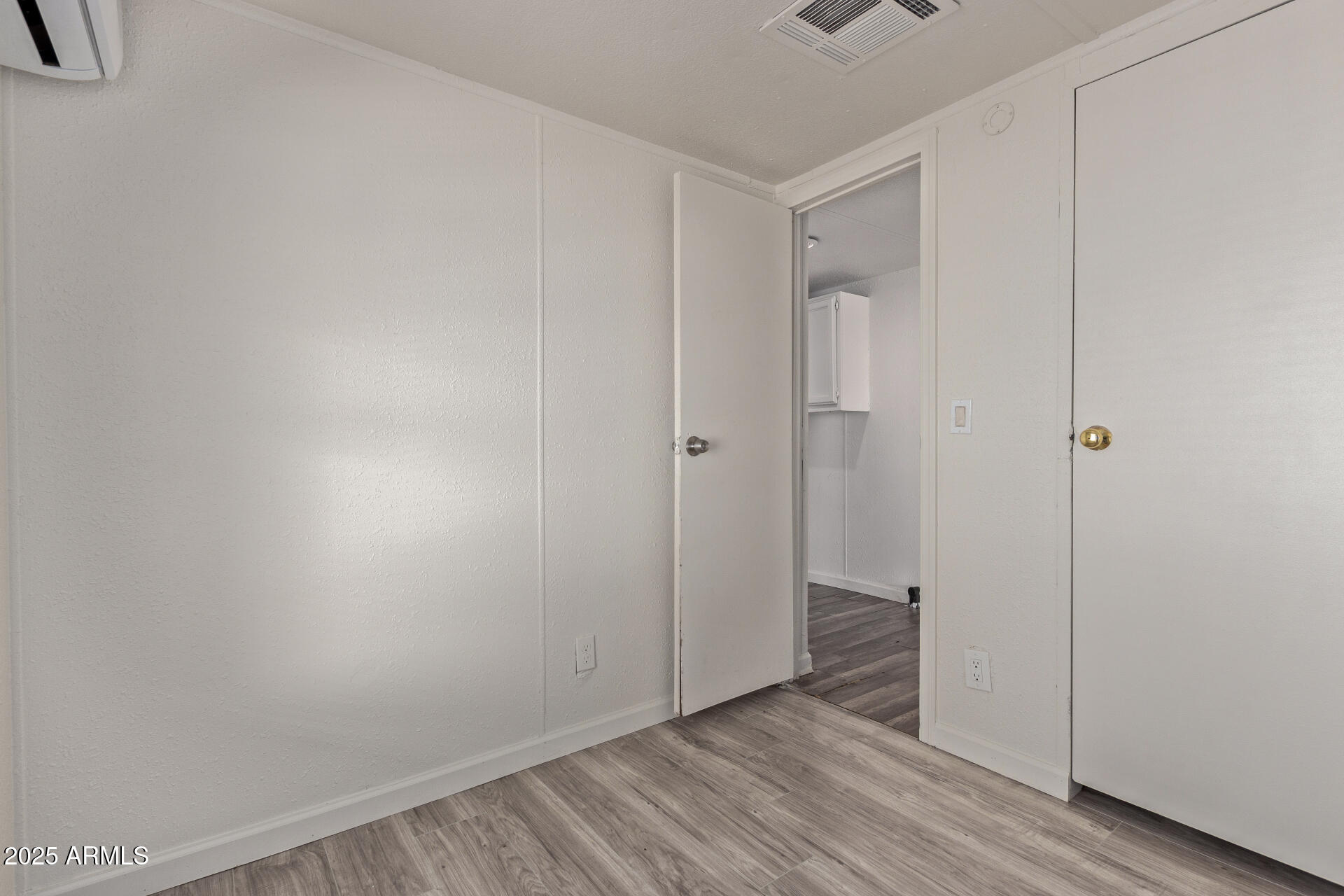 1221 North Dysart Road, Unit 35 Avondale, AZ 85323 - Photo 18 of 22 a view of an empty room with wooden floor