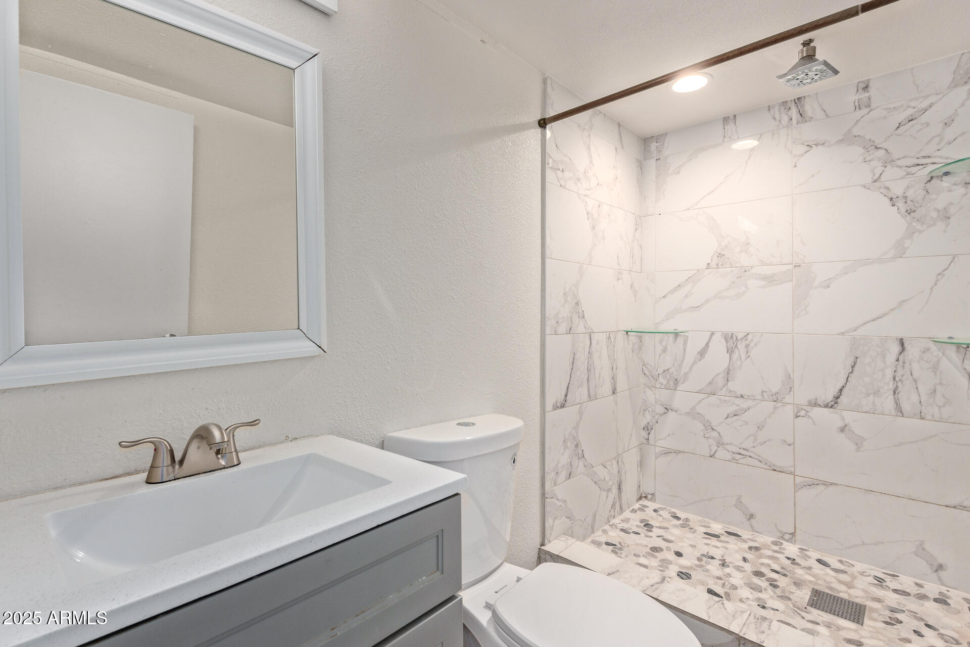 1221 North Dysart Road, Unit 35 Avondale, AZ 85323 - Photo 19 of 22 a bathroom with a sink toilet and shower
