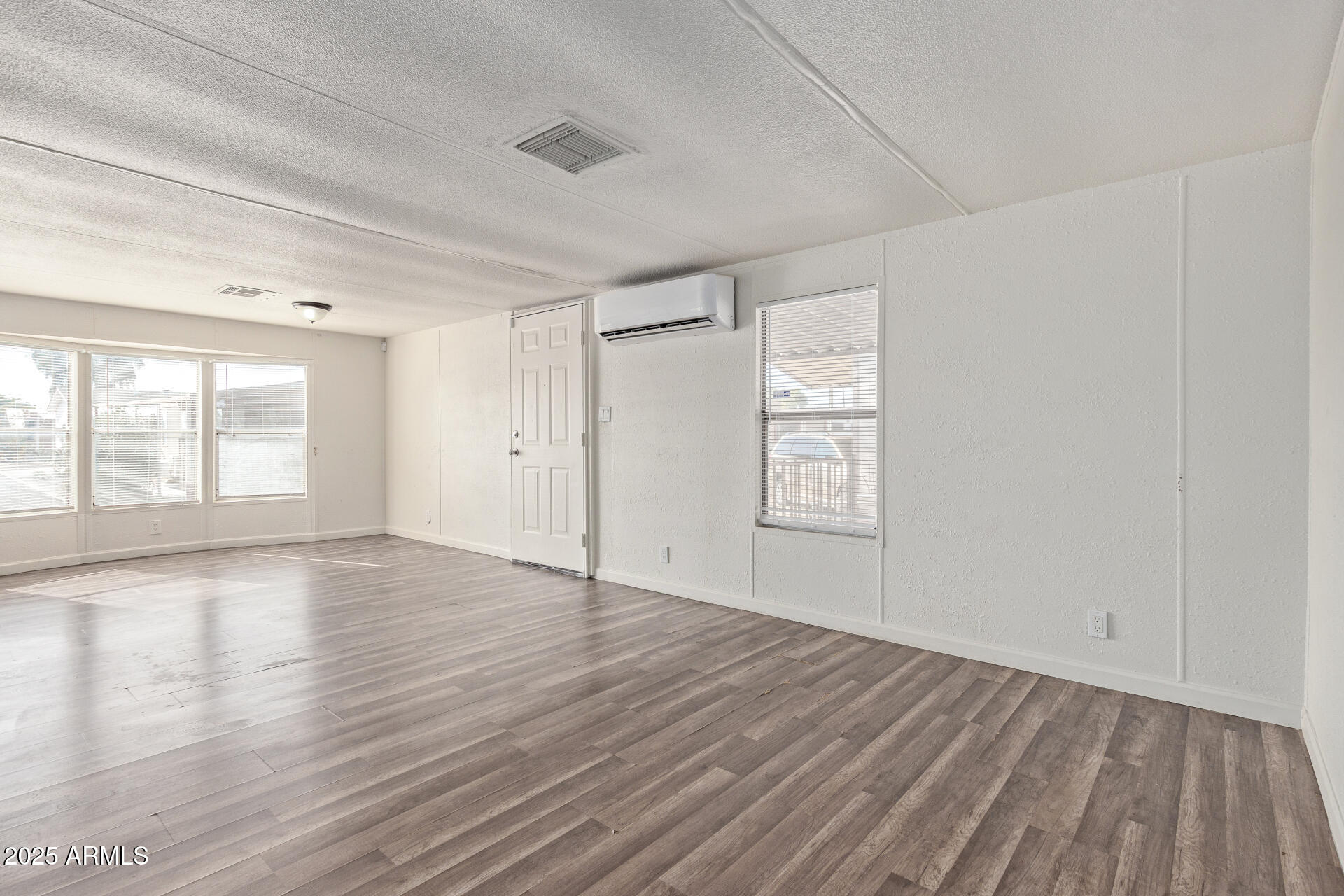 1221 North Dysart Road, Unit 35 Avondale, AZ 85323 - Photo 6 of 22 wooden floor in an empty room with a window