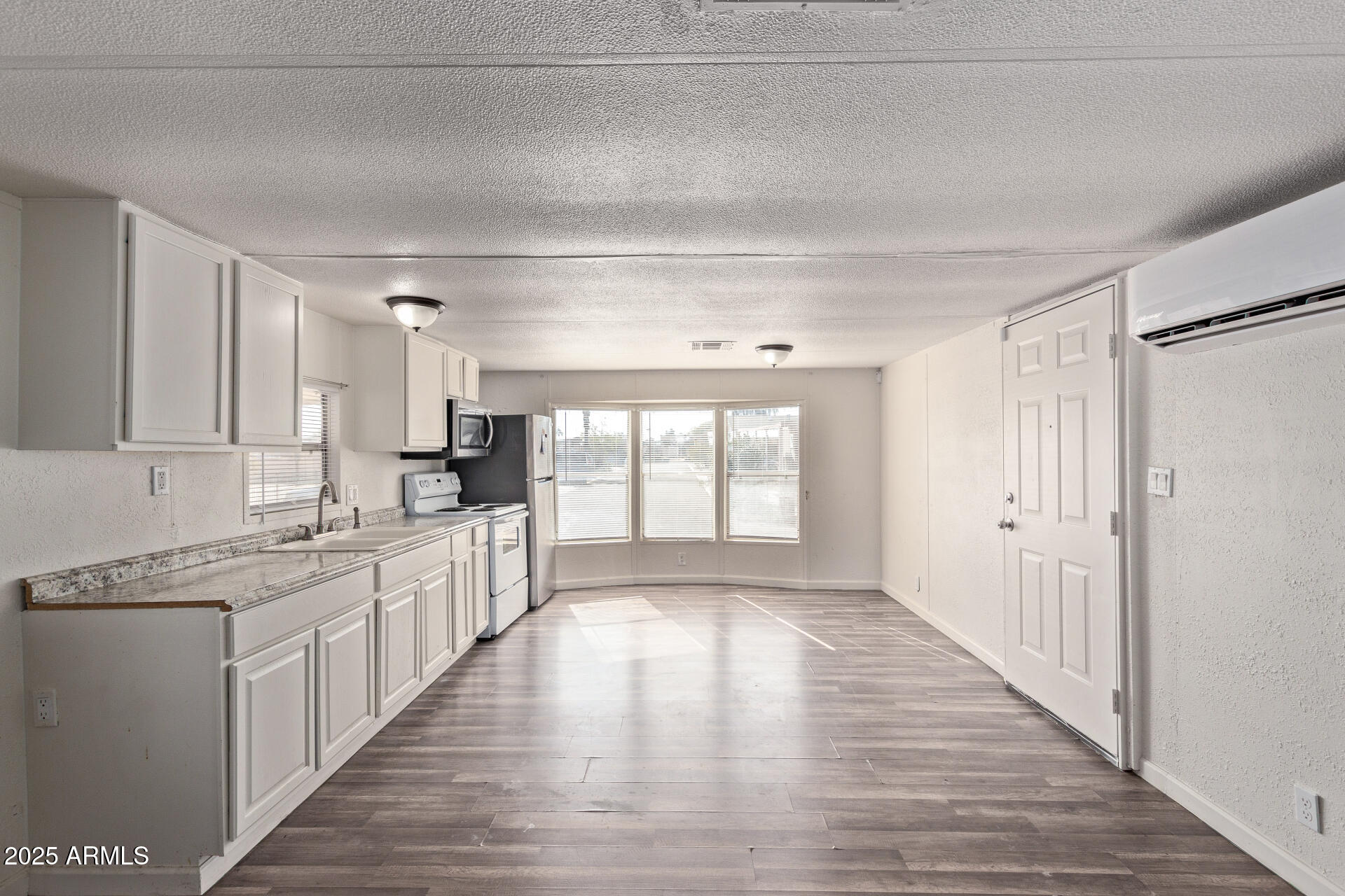 1221 North Dysart Road, Unit 35 Avondale, AZ 85323 - Photo 9 of 22 a large kitchen with cabinets and wooden floor